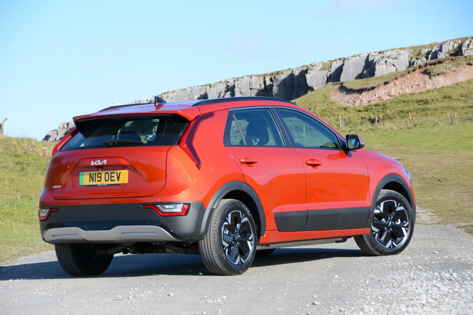 Kia Niro EV rear on road mountain path